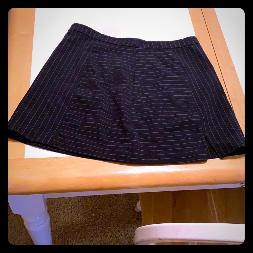 A navy blue and white stripped mini skirt
